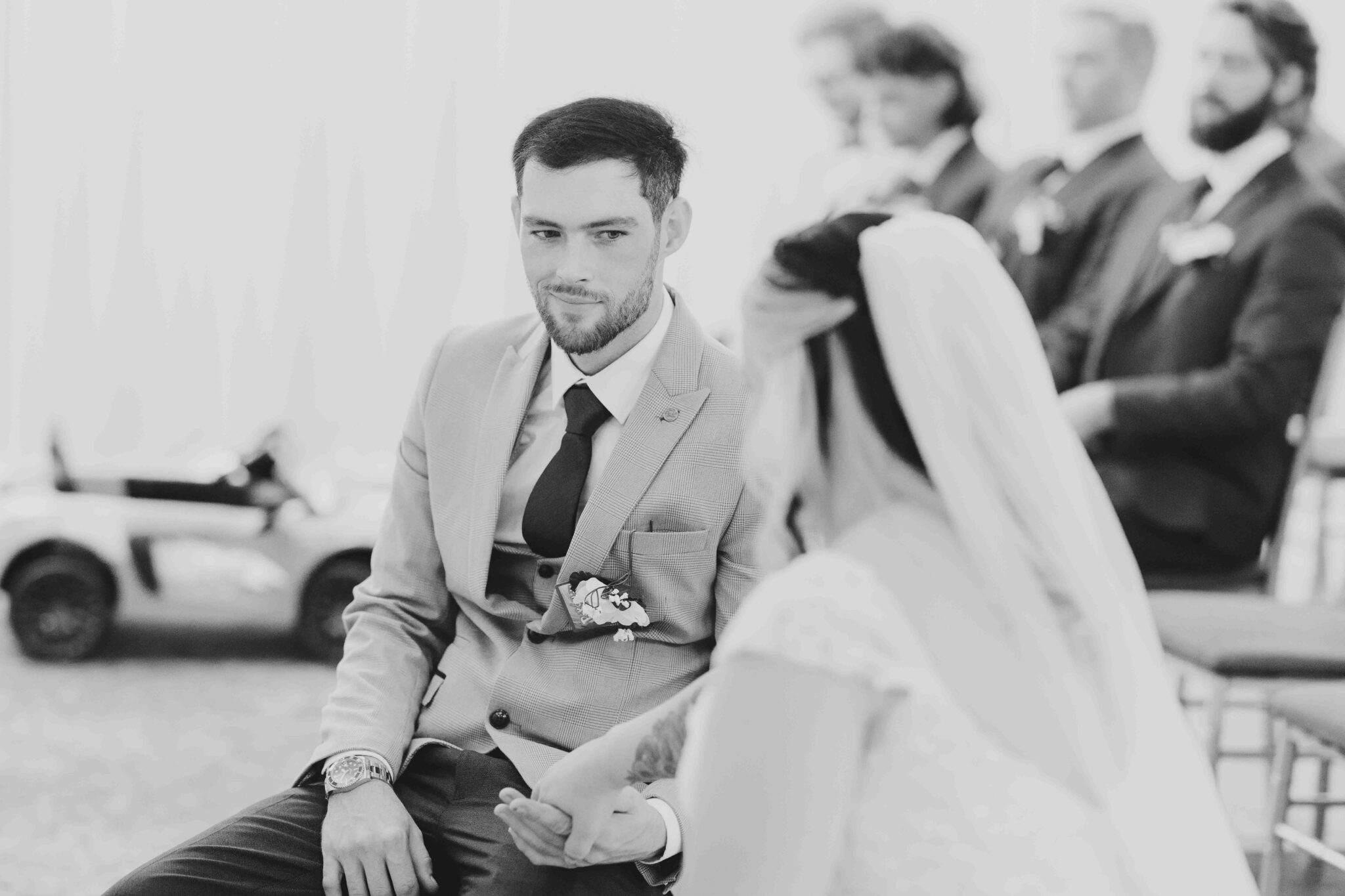 Black and white photo of Brandon waiting at the top of the aisle as Shannon arrives, Talbot Hotel Cork wedding