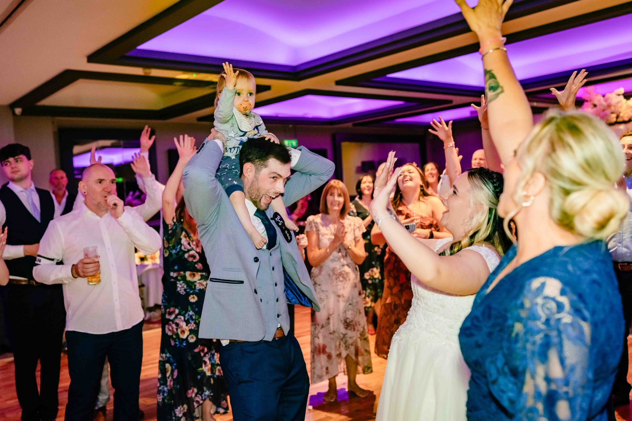Shannon, Brandon and guests dance with their hands in the air at the Talbot Hotel Cork wedding reception