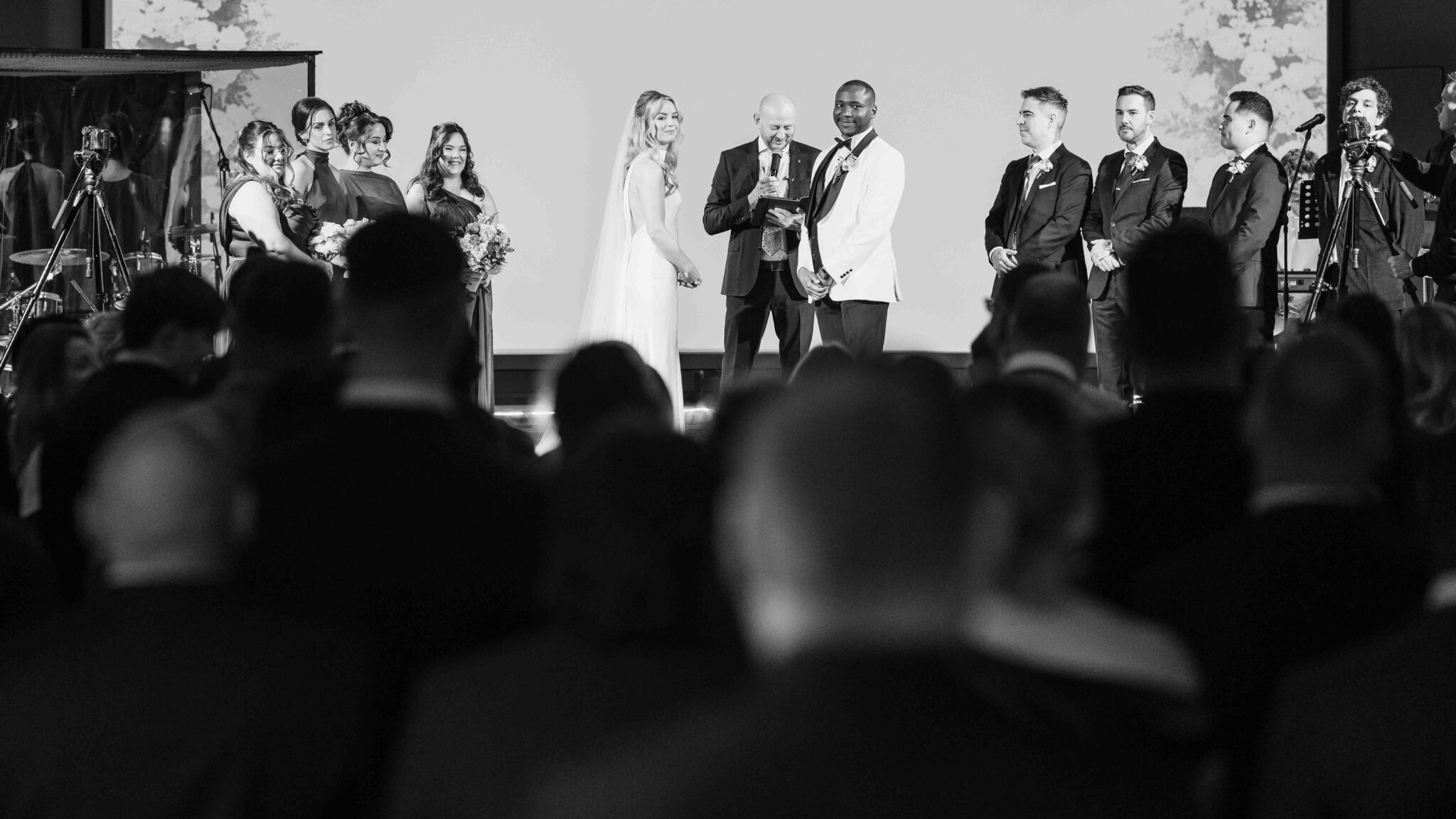 Black and white wide view of the wedding ceremony on stage at Cork Church, wedding photographers Cork