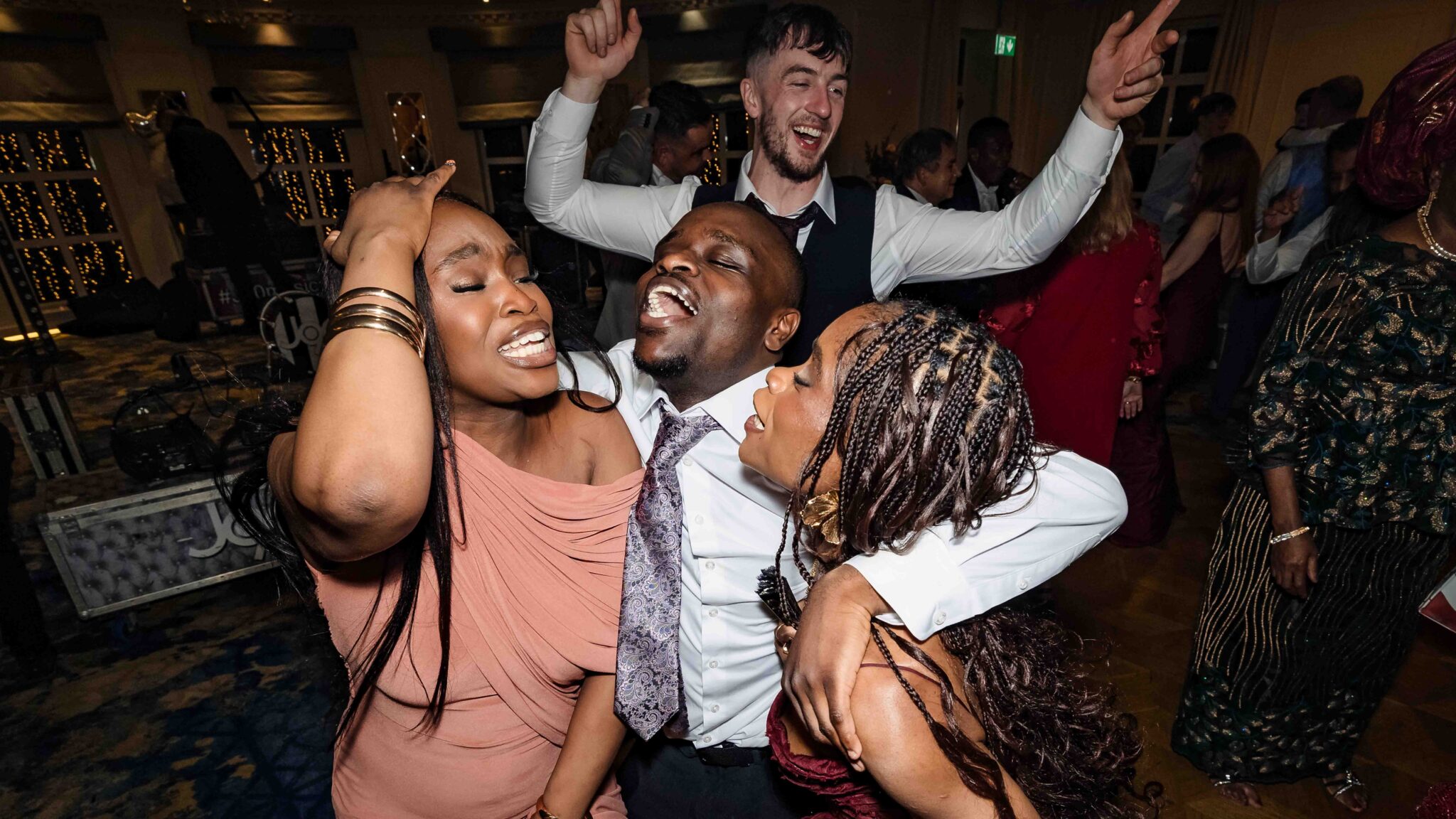Wedding guests sing and dance together, lost in the music, at Vienna Woods Hotel, Cork wedding photographer