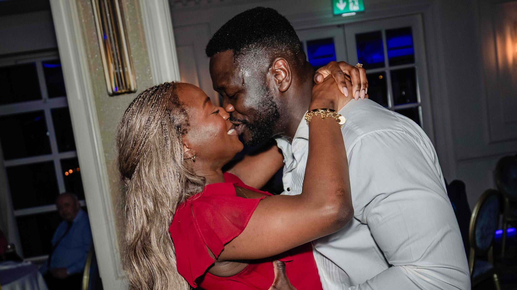 Two guests share a kiss on the dance floor at the Vienna Woods Hotel wedding reception, Cork