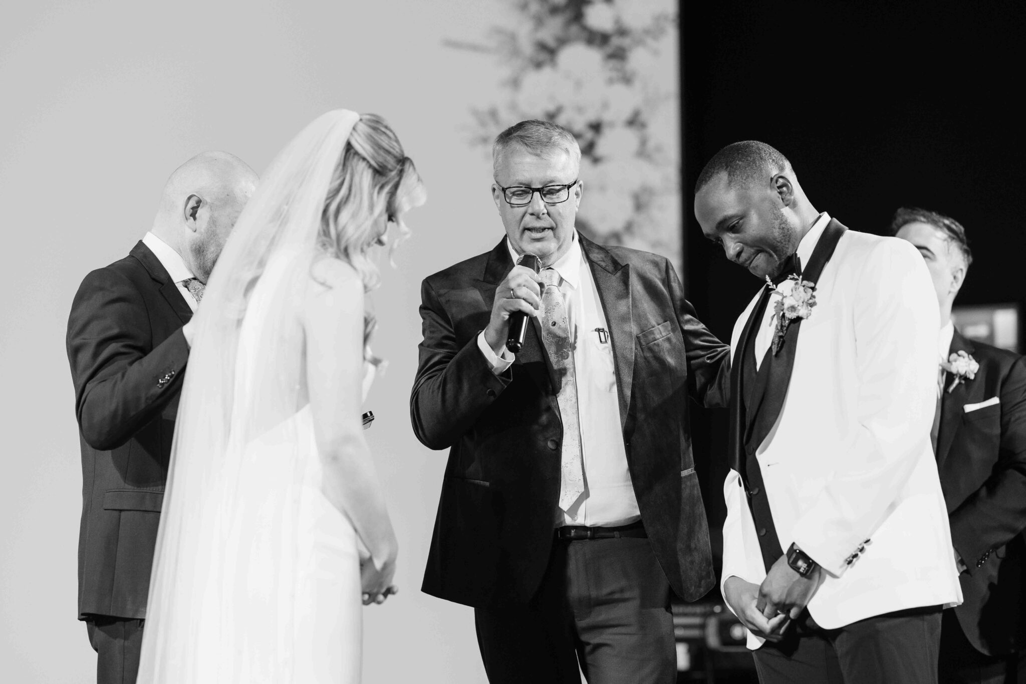 Pastor leads the blessing as the bride and groom bow their heads at Cork Church, Cork wedding photography
