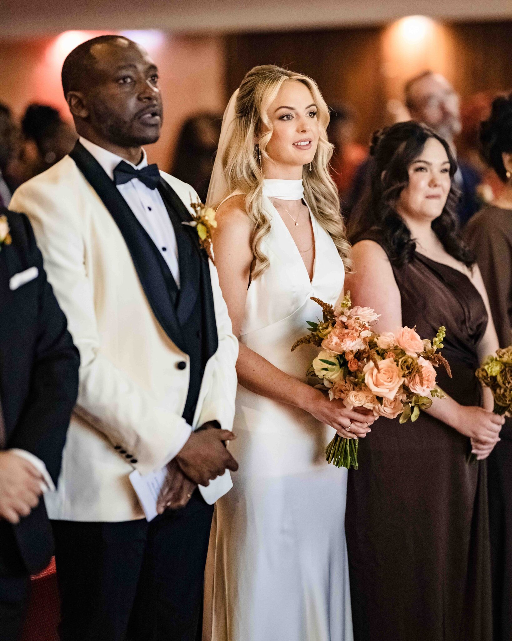 Groom in a white dinner jacket with the bride and a bridesmaid in chocolate brown satin after the ceremony, Cork