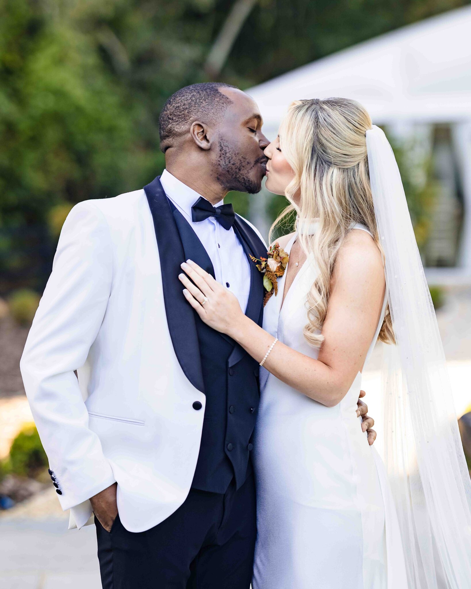 Groom Mahan kisses Stacey's cheek in the gardens at Vienna Woods Hotel, Cork wedding photography