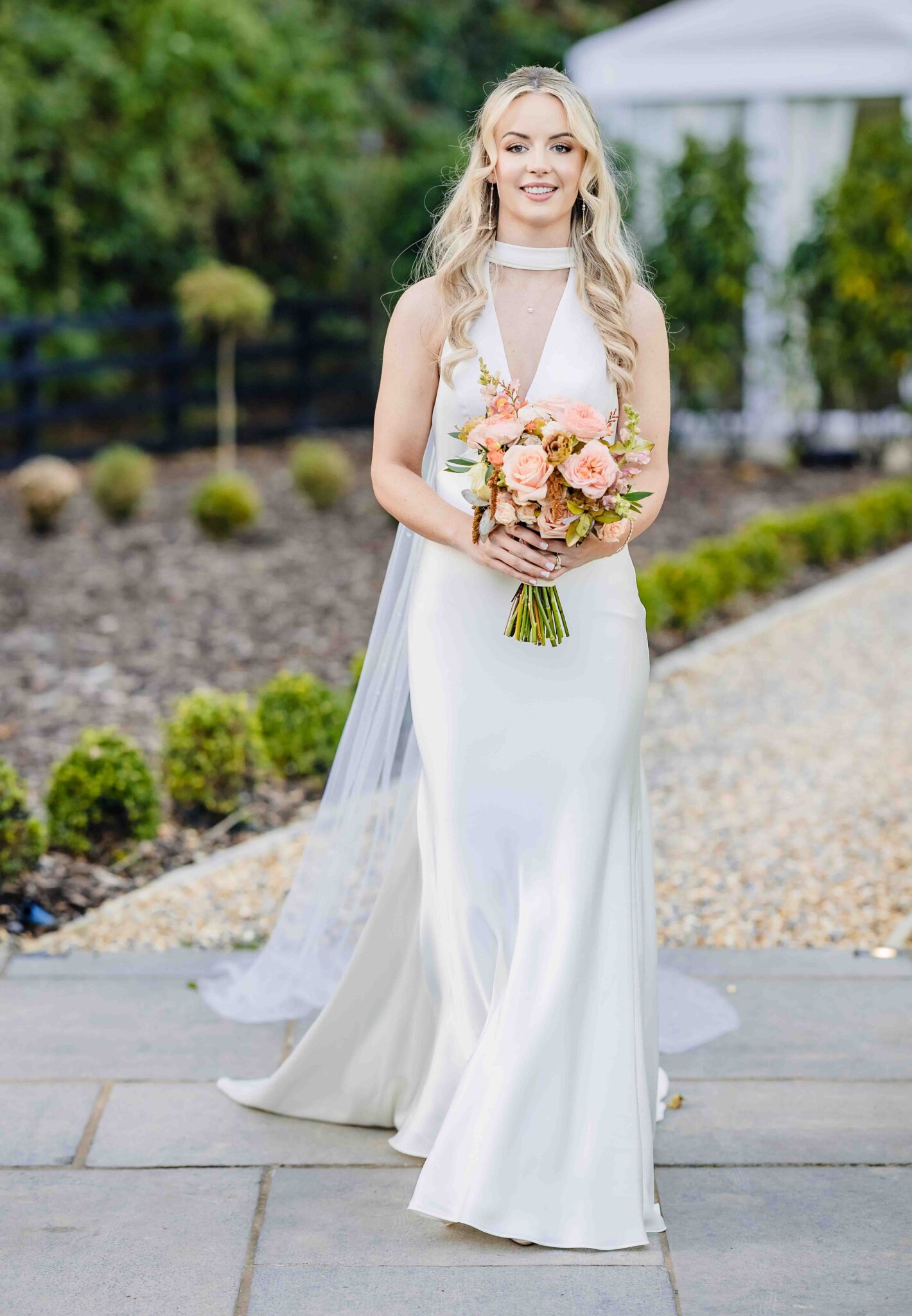 Bride's long veil flows beside her satin wedding dress, Vienna Woods Hotel wedding portrait, Cork