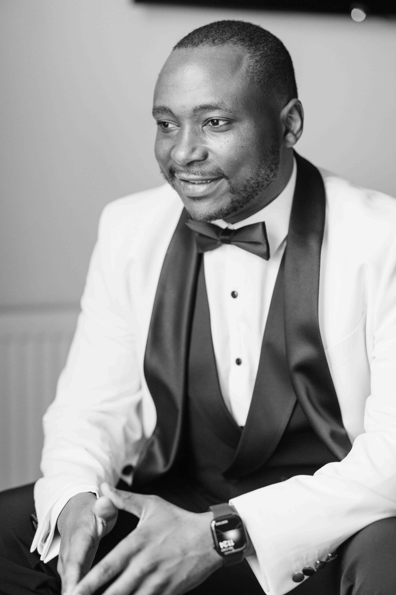 Black and white portrait of groom Mahan in waistcoat and bow tie before the wedding, Cork wedding photographer