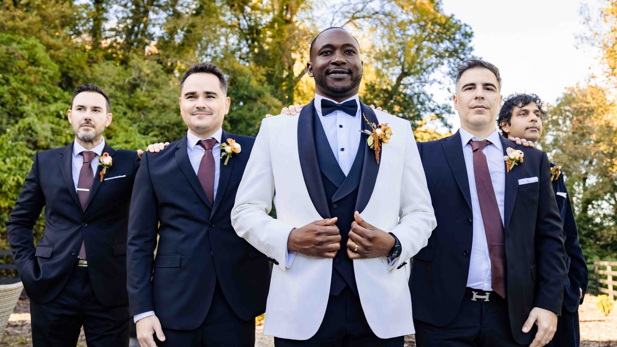 Groom Mahan in a white dinner jacket with his groomsmen in navy suits and burgundy ties, Vienna Woods Hotel, Cork wedding photographer