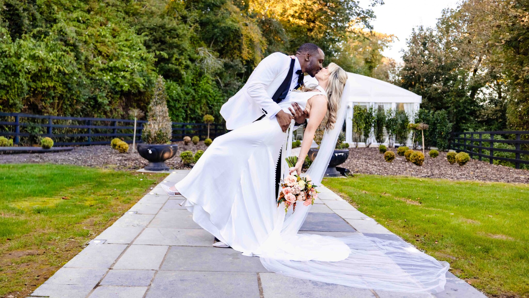 Groom dips bride for a kiss on the stone path at Vienna Woods Hotel, Cork wedding photographer JOD'Photography
