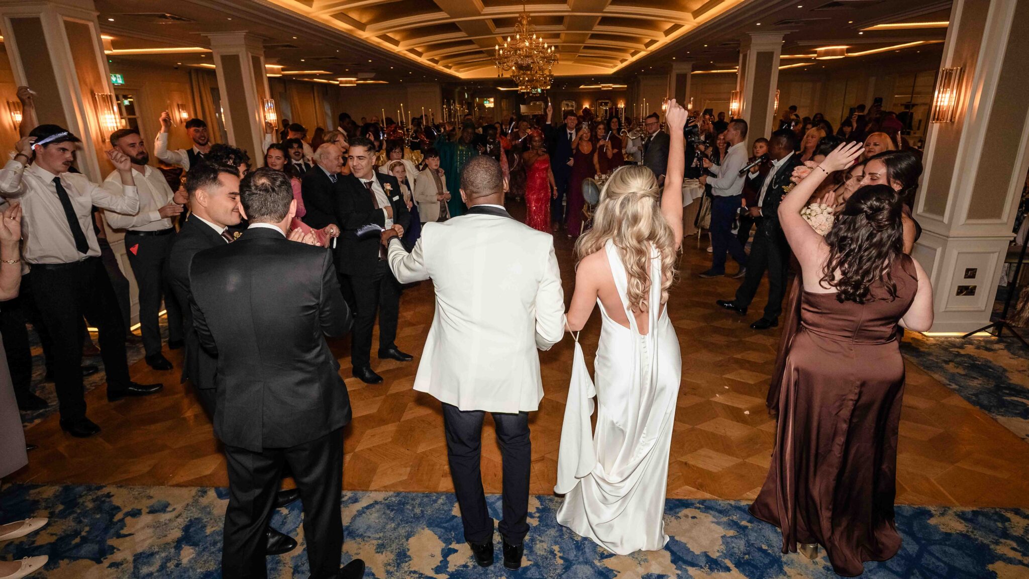 Bride and groom dance their way to the top table at the Vienna Woods Hotel wedding reception, wedding photographers Cork