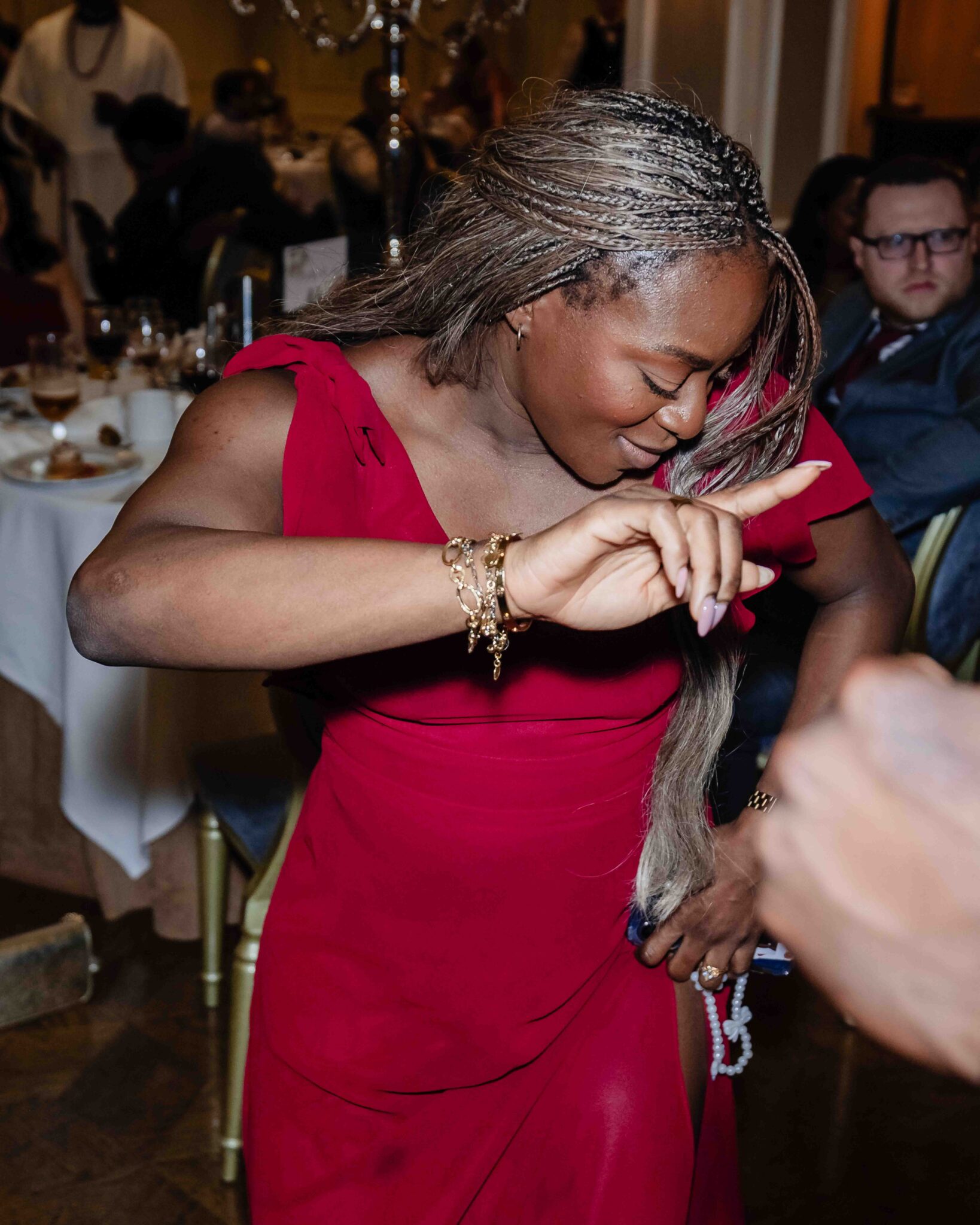 Guest in a red dress dances in the ballroom at Vienna Woods Hotel, Irish Nigerian wedding in Cork