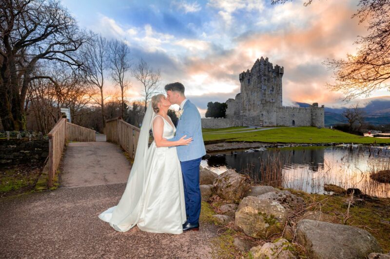 Bride and groom sharing a quiet moment at sunset with Ross Castle behind them Killarney Co Kerry-JOD'Photography