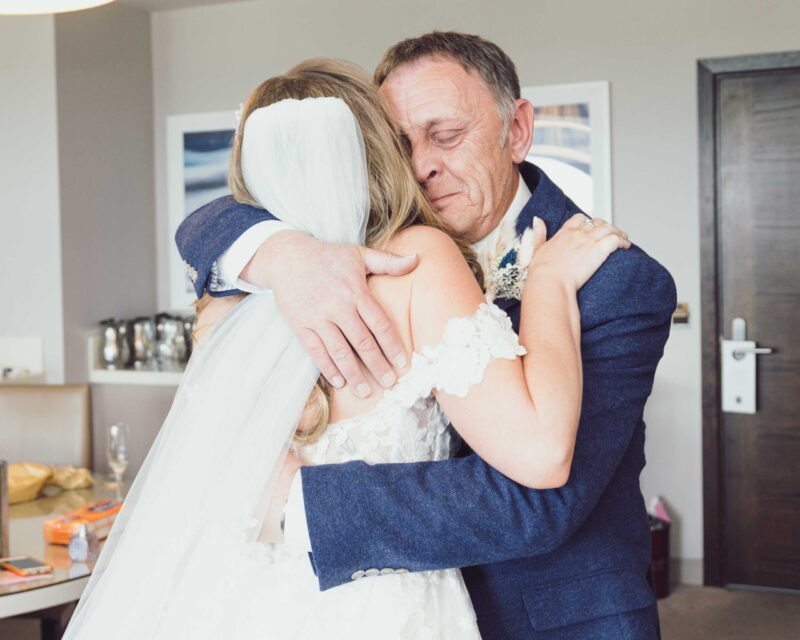Lucca’s suit being adjusted by his groomsman – JOD’Photography