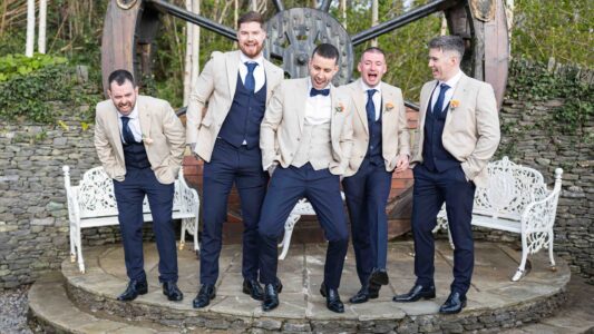 Groom and groomsmen laughing during morning prep in Kerry