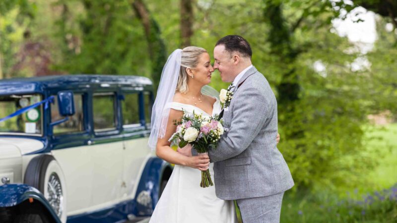 Bride and groom photographed naturally beside the river in Cork