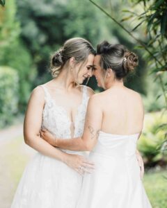Bride and bride laughing together in the Fernhill House gardens – JOD Photography