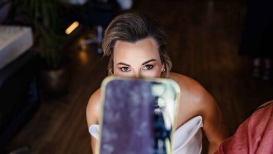 Bride smiling during bridal preparations in the Styling Lounge at Fernhill House – JOD Photography