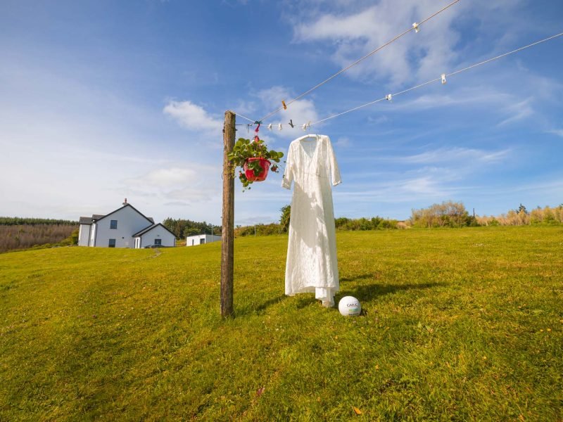 Wedding dress hanging on the line with a stunning blue sky behind it, up the Mountains in Macroom Co Cork